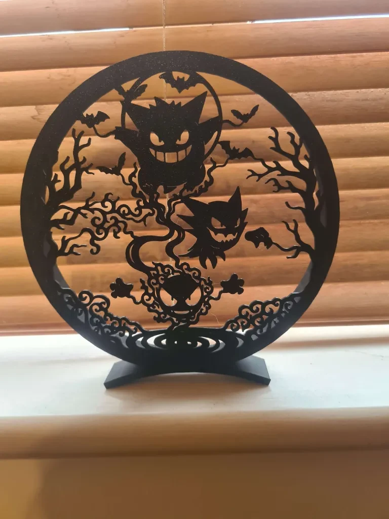 Black 3D-printed circular display featuring Gastly, Haunter and Gengar